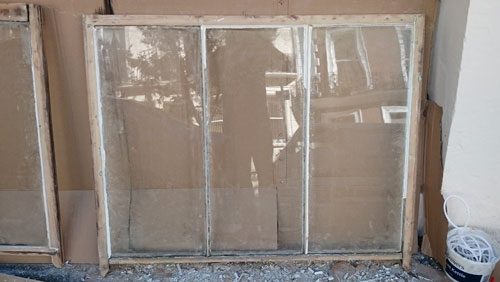 this shows the window being stripped of all paint before the restoration begins in the Brunswick conservation area Hove East Sussex