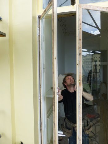 Regency french doors getting rehung i in the Brunswick Square Regency door restoration project, Hove East Sussex