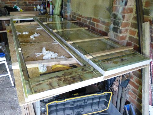 Fully restored doors with all the rot completely gone in the workshop, this is also showing that we always use preservative on the timber